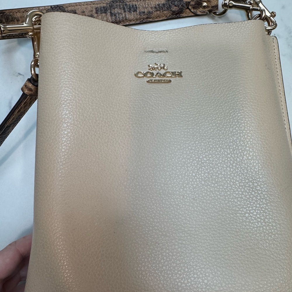 Ivory coach bucket bag